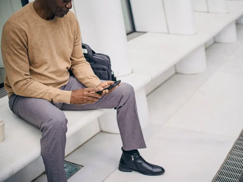 Business owner reviewing new leads on his phone